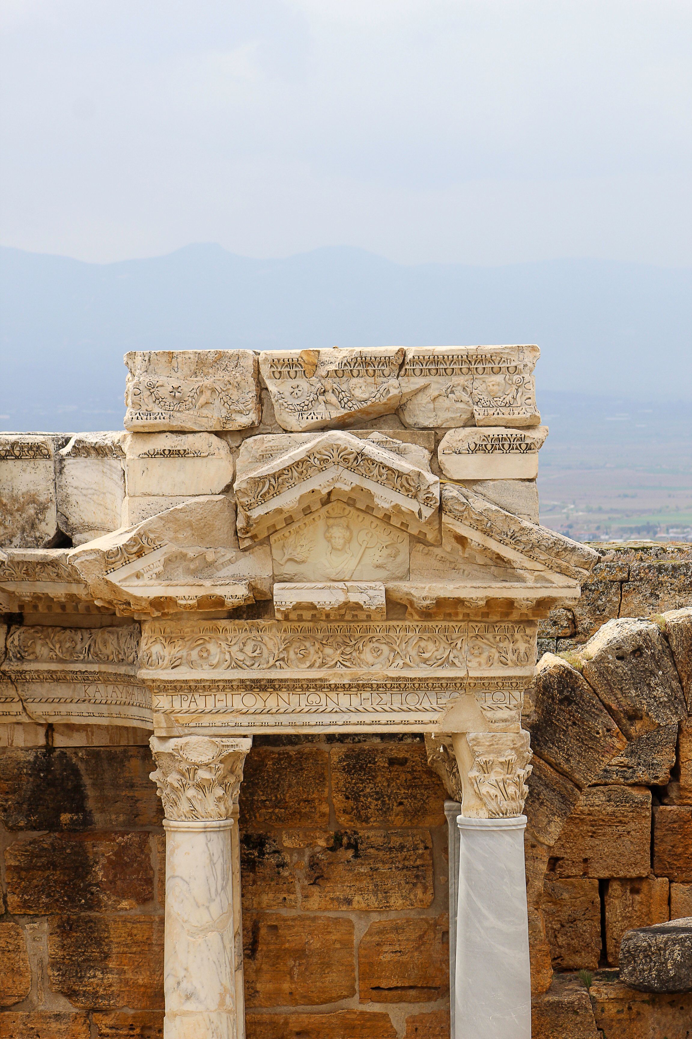 Detailed view of ancient Roman ruins at Hierapolis in Turkey, showcasing intricate stone carvings.