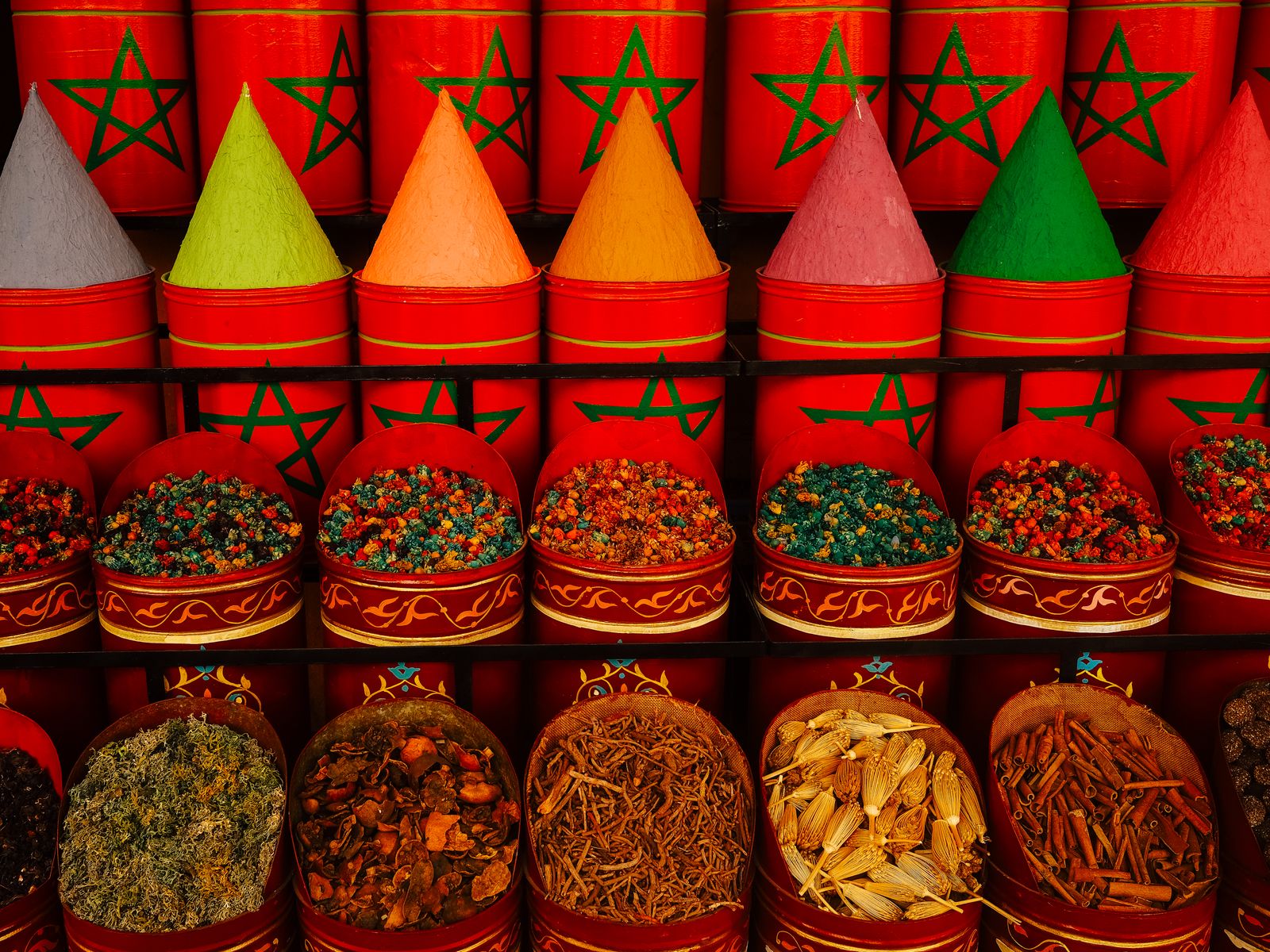 Vibrant display of traditional spices in colorful cones at Moroccan market