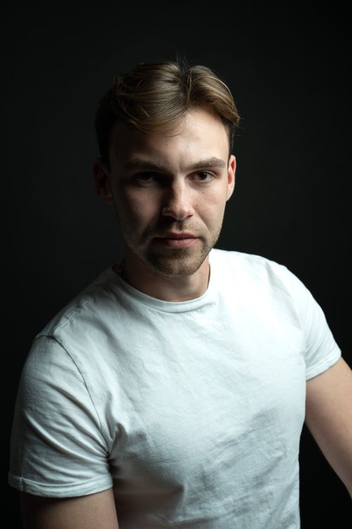 Free Intense studio portrait of a young male in Berlin, showcasing dramatic lighting and emotion. Stock Photo