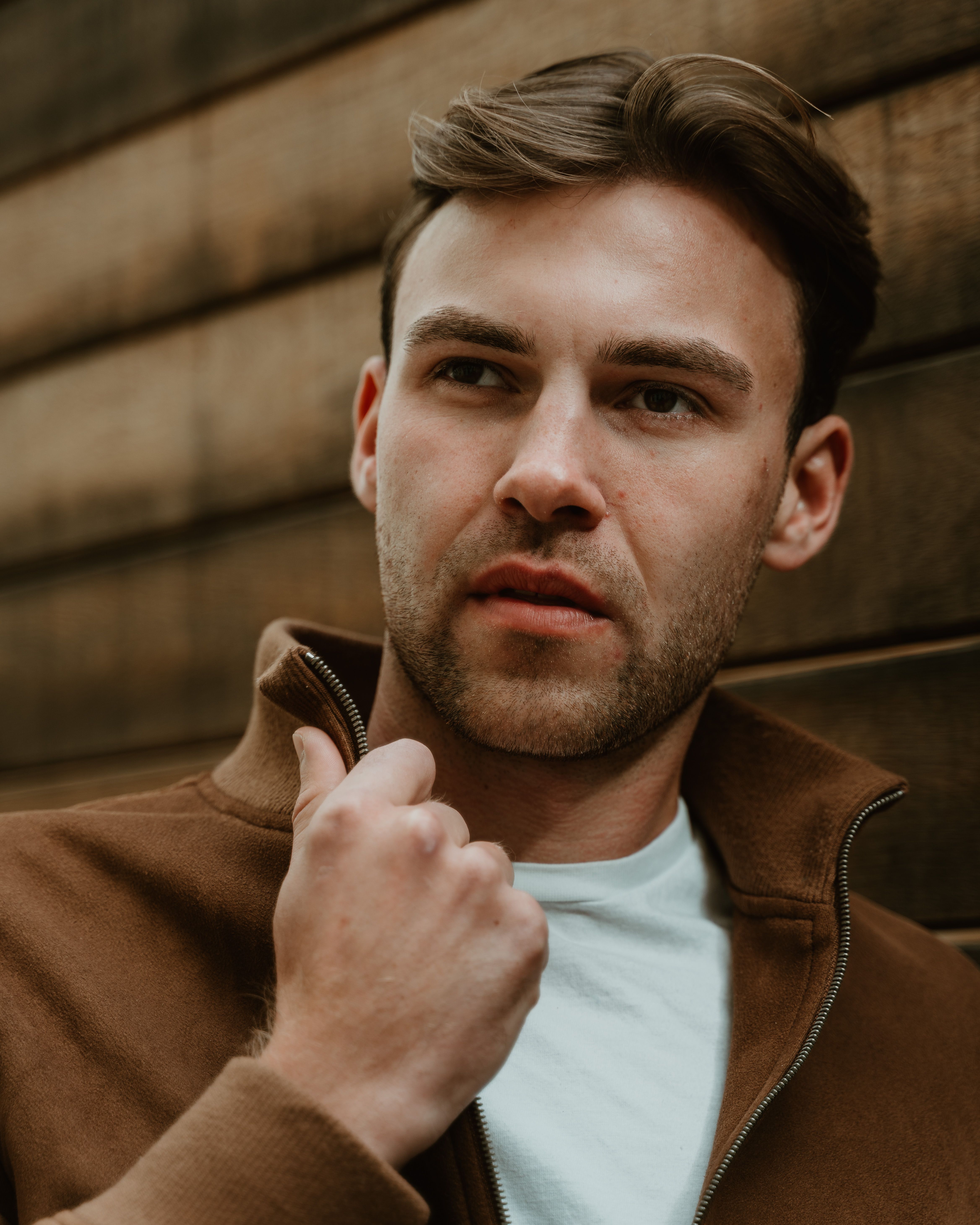 Elegant outdoor portrait of a man with emotional expression in Berlin, Germany.