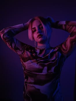 Stylish portrait of a young woman in vibrant neon lighting, creating a moody atmosphere.