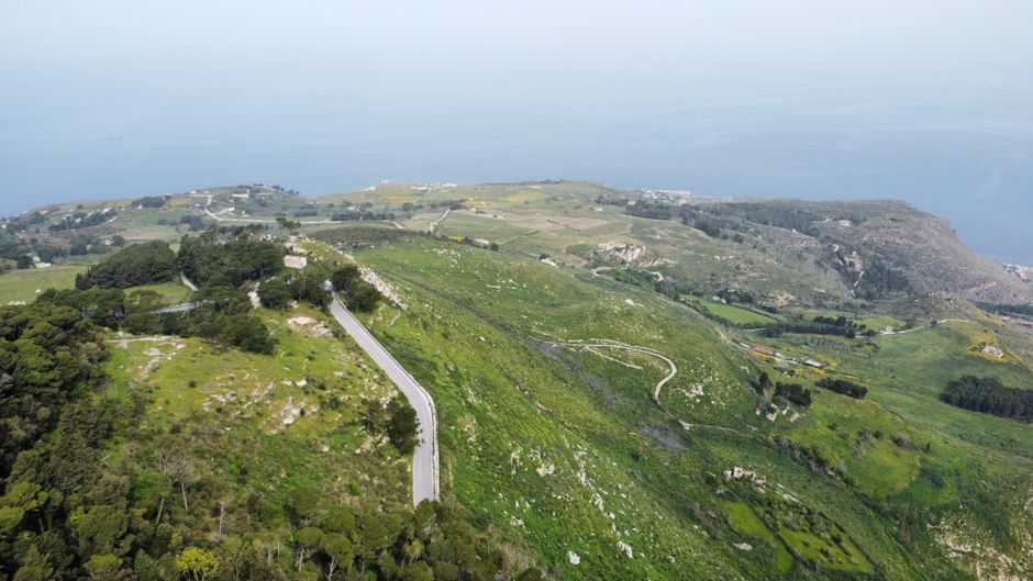 Spectacular Etna: Group Helicopter Flight (30 Minutes from Fiumefreddo) Review Review 2026 - Discover breathtaking aerial views of lush green hills and a serene coastline under a clear sky.