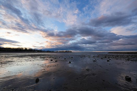 Breathtaking sunrise over Cove Island Park in Stamford, Connecticut, showcasing a serene low tide scene.