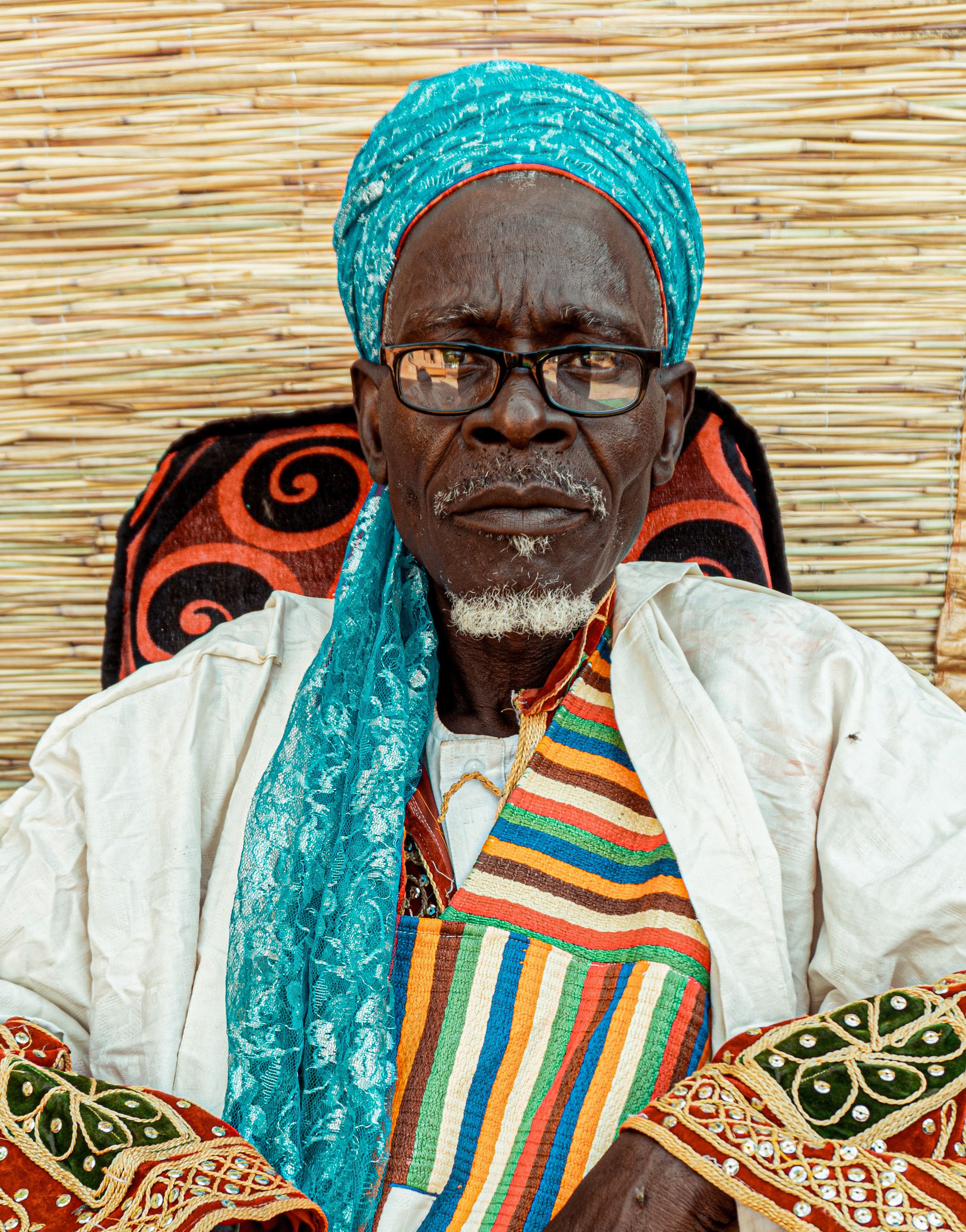 Portrait of a Nigerian elder in colorful traditional attire, exuding cultural pride.