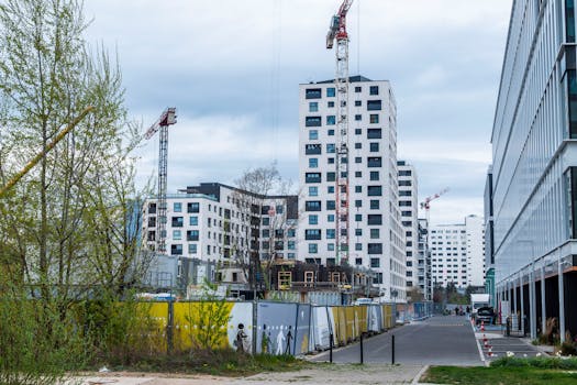 High-rise buildings and cranes in an urban construction site. Modern architecture.