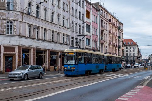 Free Street view of city with tram and historic architecture under cloudy sky. Stock Photo