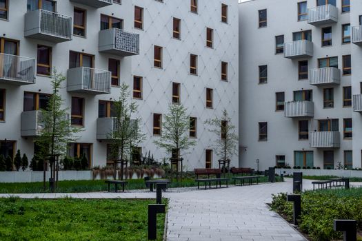 Contemporary apartment complex with landscaped courtyard and balconies.