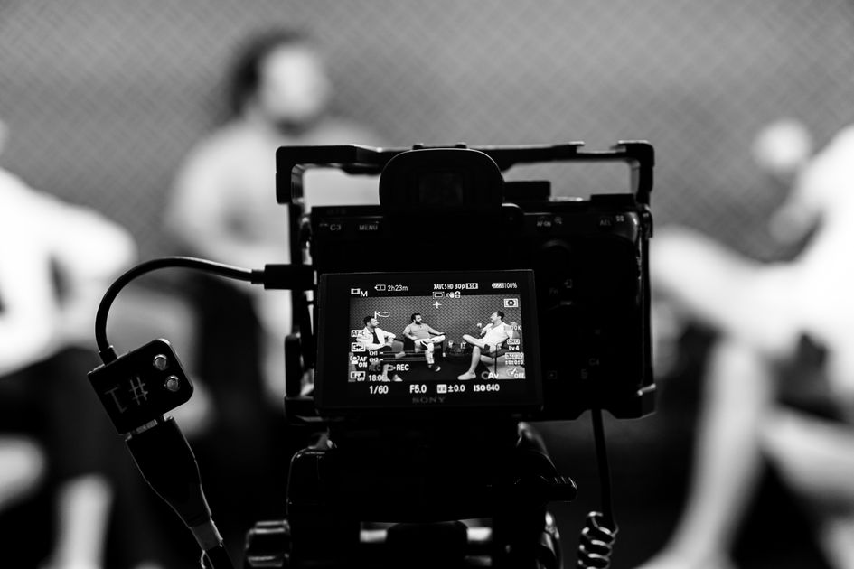 Camera capturing an indoor interview scene with a blurred background