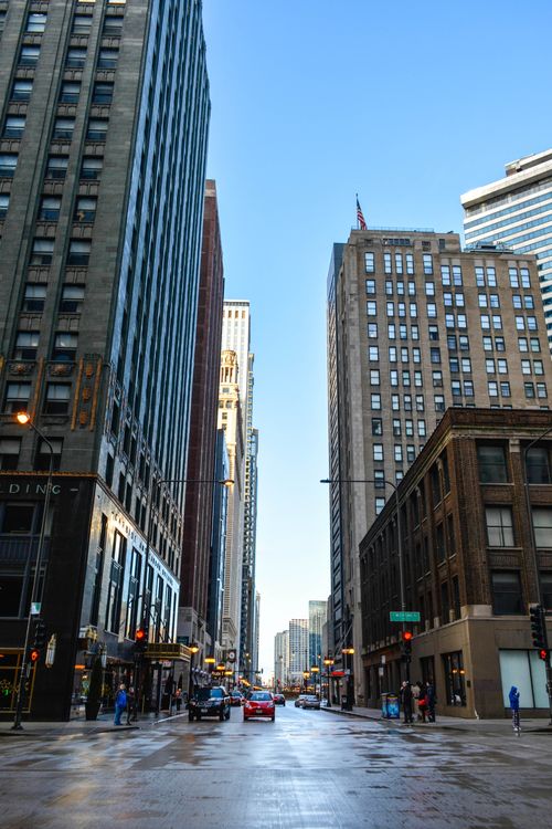 Free Vibrant street view of downtown Chicago with towering skyscrapers under a clear blue sky. Stock Photo