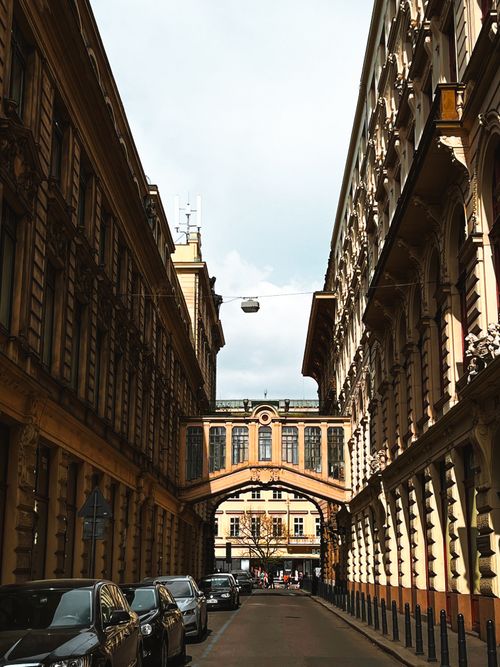 Free Street view showcasing classic European architecture with a skybridge connecting buildings. Stock Photo