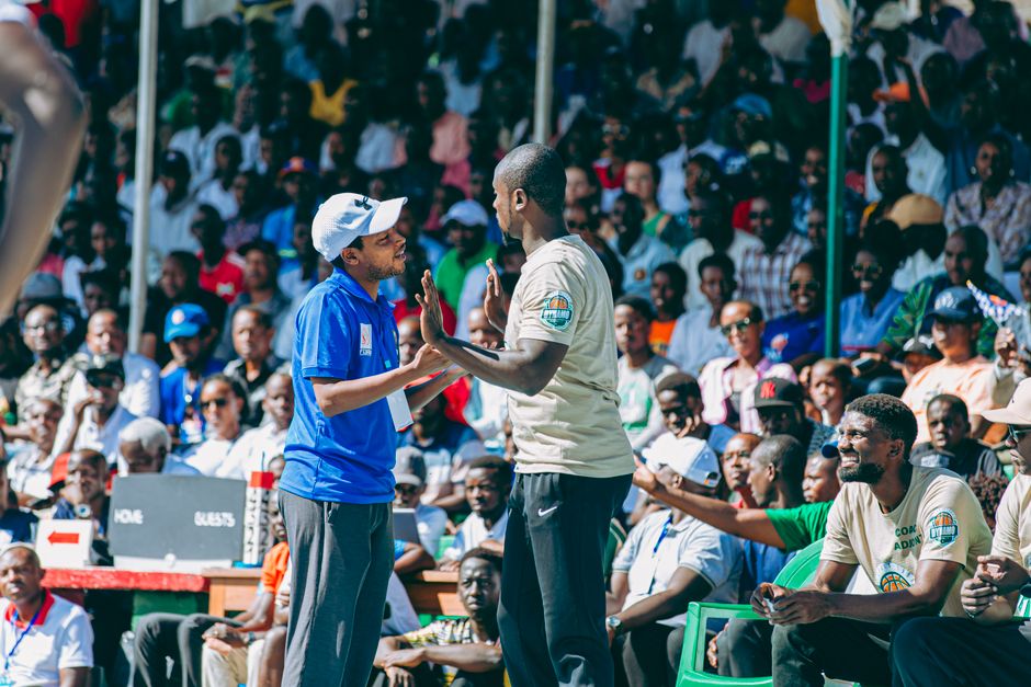 Exciting crowd at a sports event with engaging interactions among attendees.