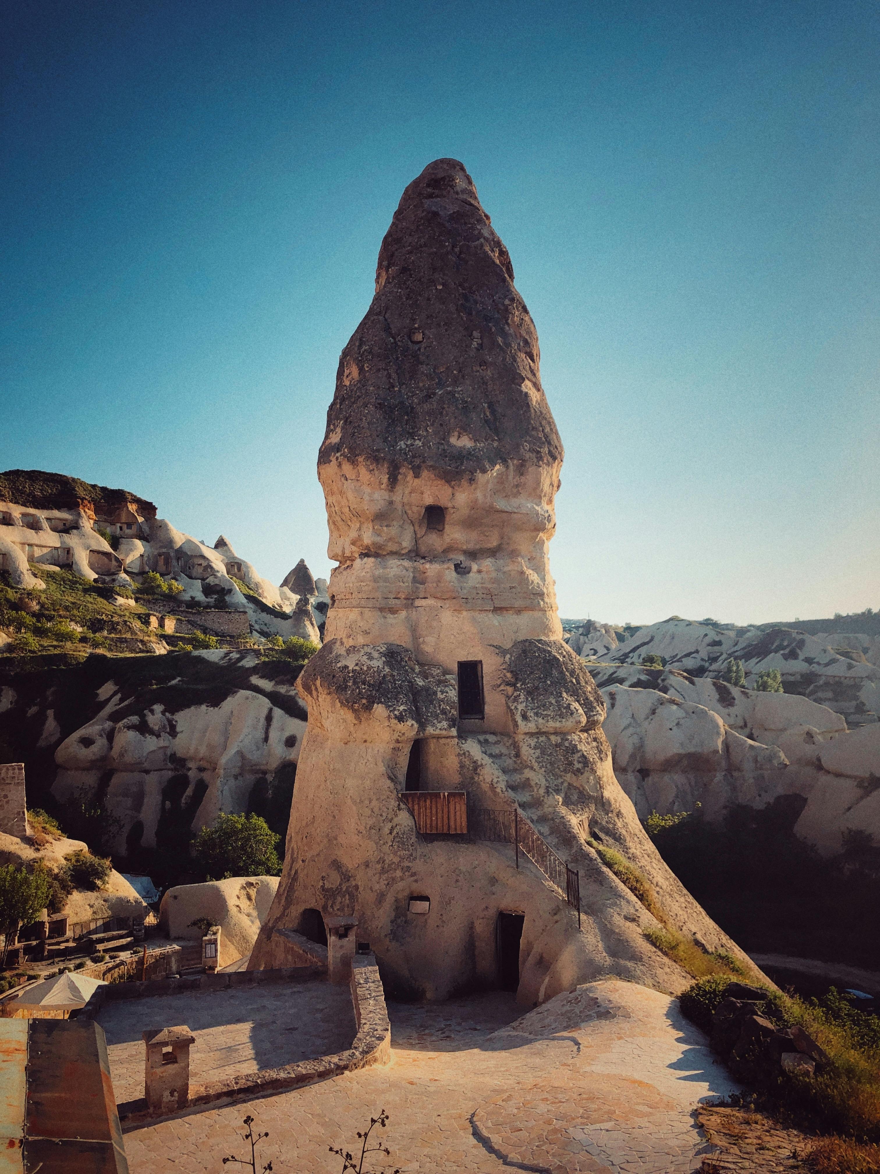 Stunning view of a fairy chimney rock formation in Cappadocia, Turkey, under a clear blue sky.