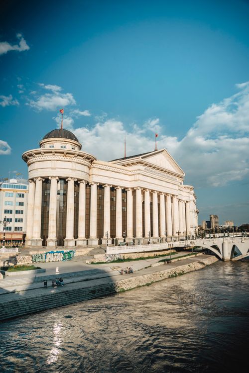 Free Stunning view of neoclassical Skopje architecture by the river on a sunny day. Stock Photo