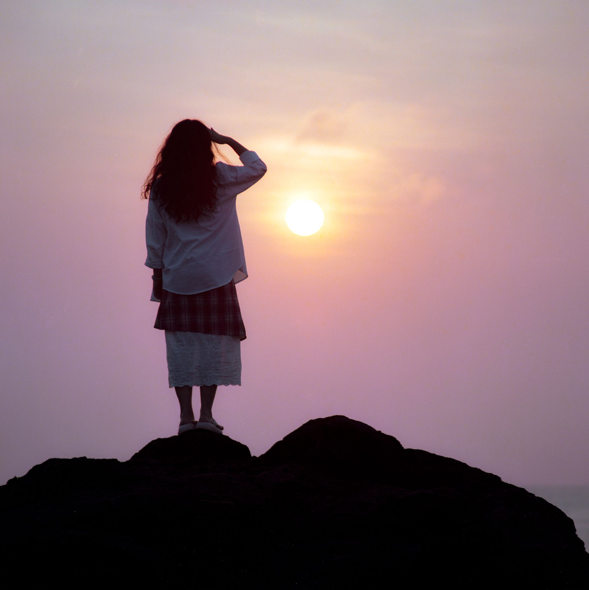 Silhouette of Woman Watching Sunset on Quang Ngai Cliff · Free Stock Photo
