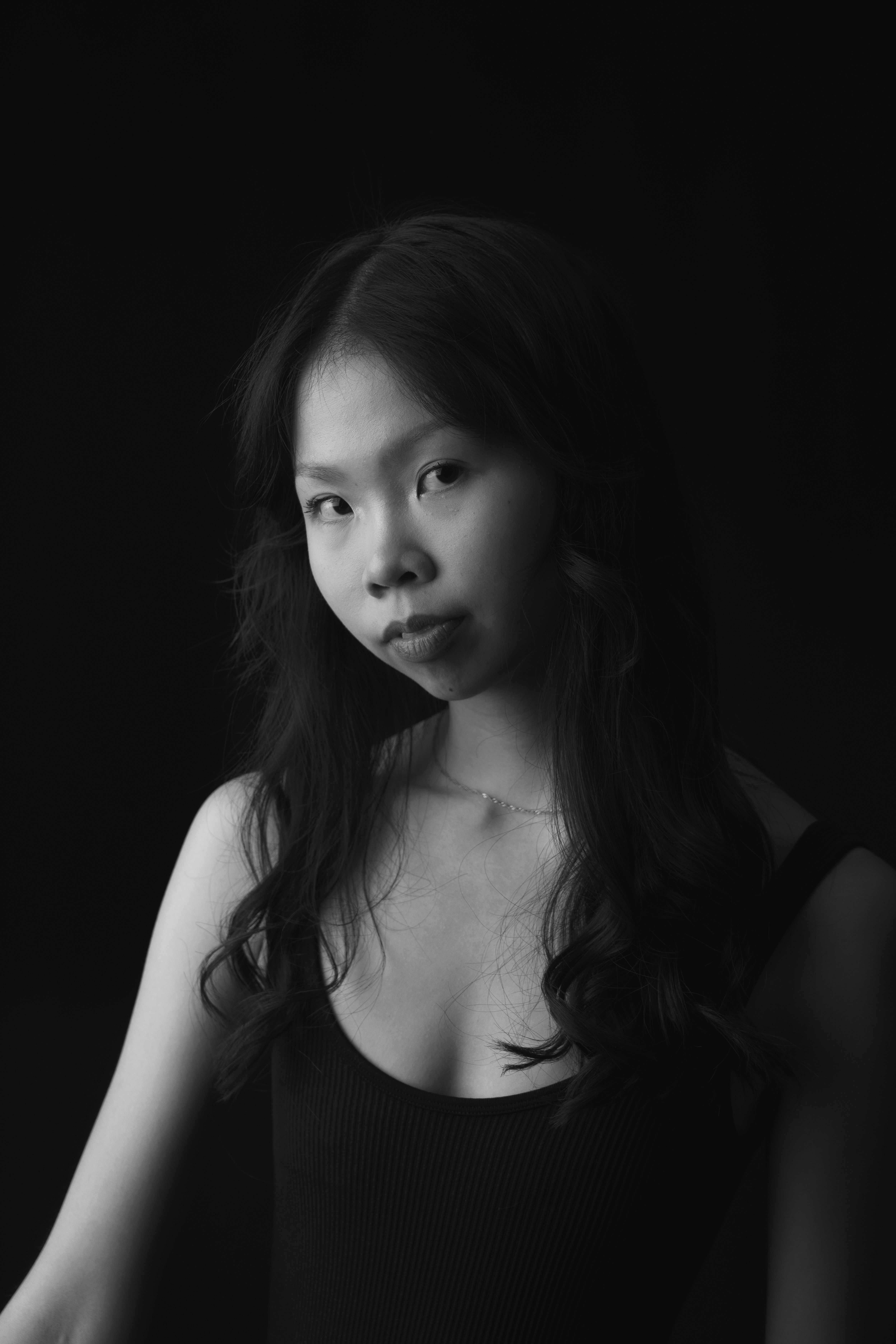 Striking black and white portrait of a young woman with expressive gaze.