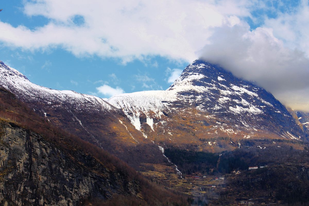 Snow covered mountains and valleys in Norway under a blue sky
