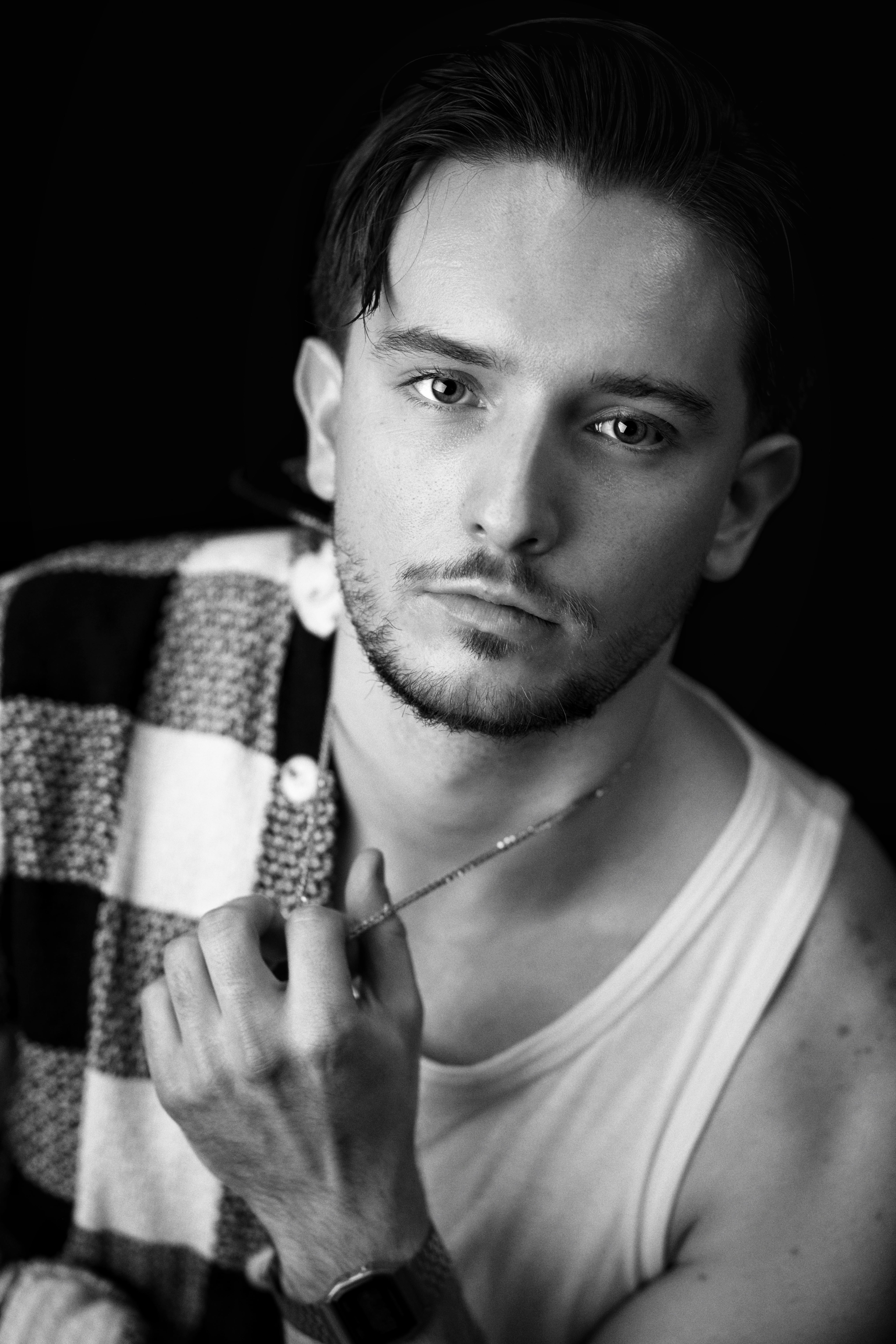 Striking black and white portrait of a contemplative adult man.