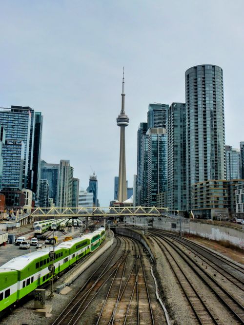 Free Toronto skyline featuring CN Tower and train tracks against cityscape. Stock Photo
