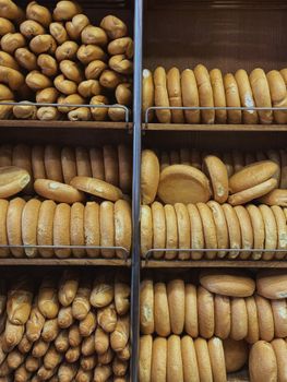 Assorted fresh breads neatly displayed in bakery shelves, ready to enjoy.