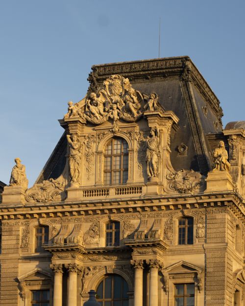 Free Close-up of a historic building's ornate Renaissance facade with intricate sculptures under a clear sky. Stock Photo