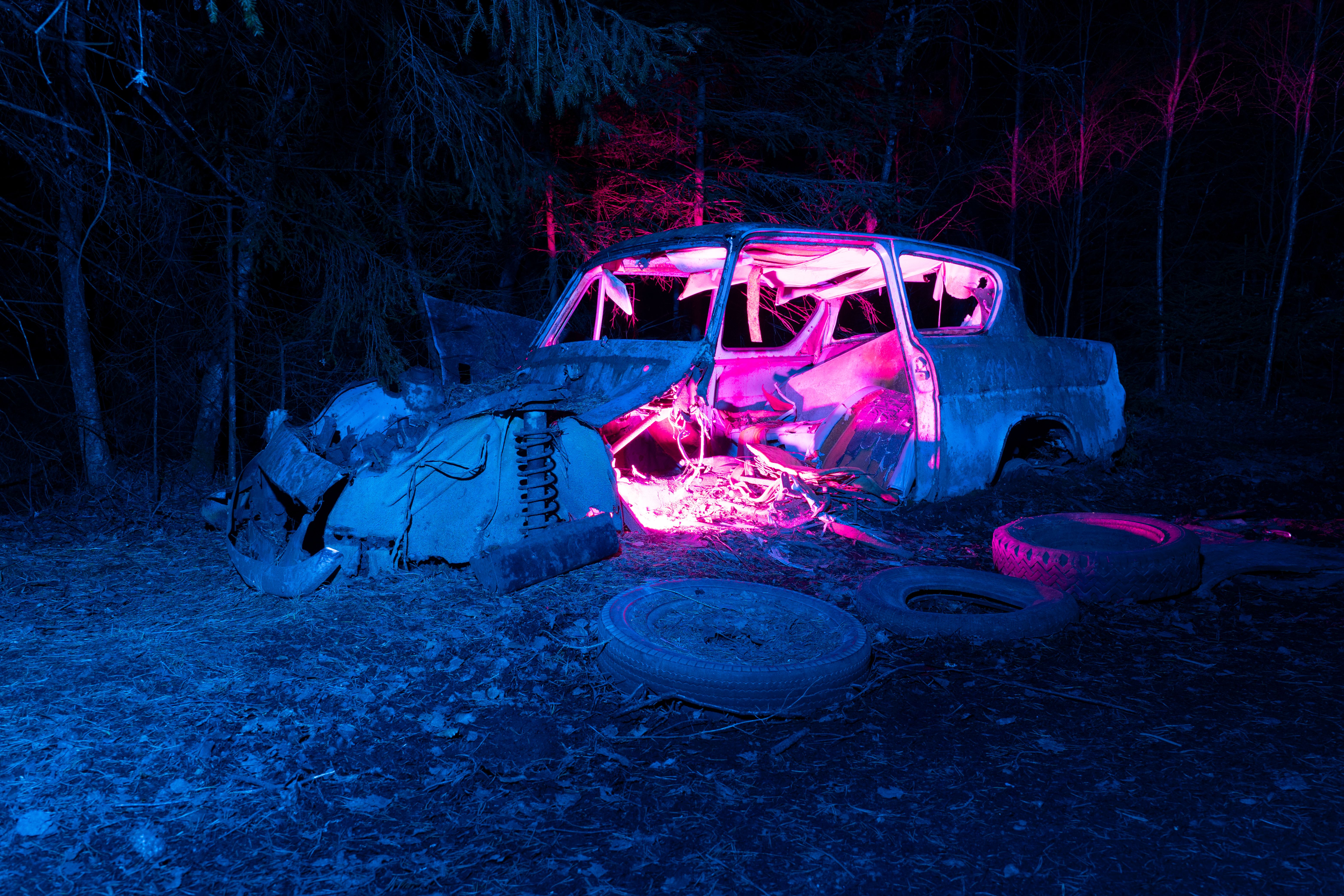 Eerie Nighttime Scene with Abandoned Car · Free Stock Photo