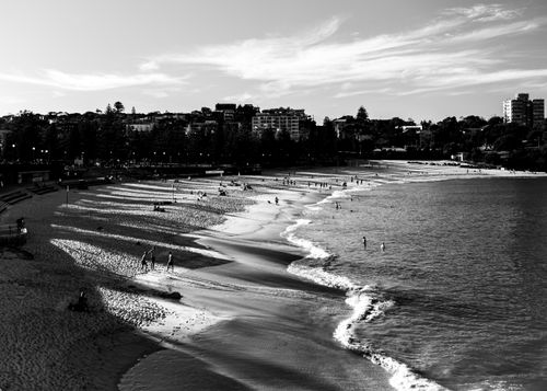 Free A dramatic black and white aerial photo of Coogee Beach, showcasing the shoreline and cityscape. Stock Photo