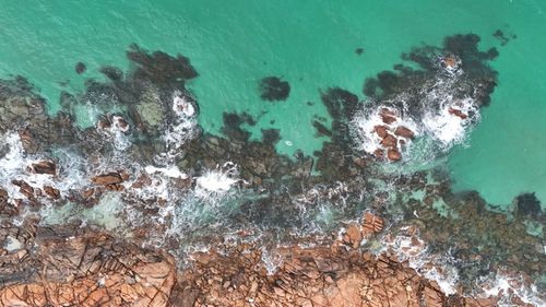 Free Stunning aerial shot of rugged Busselton coastline with turquoise waves crashing on rocks. Stock Photo