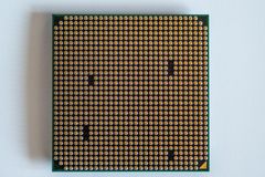 Detailed view of a computer processor, showcasing its pins, against a clean white backdrop.