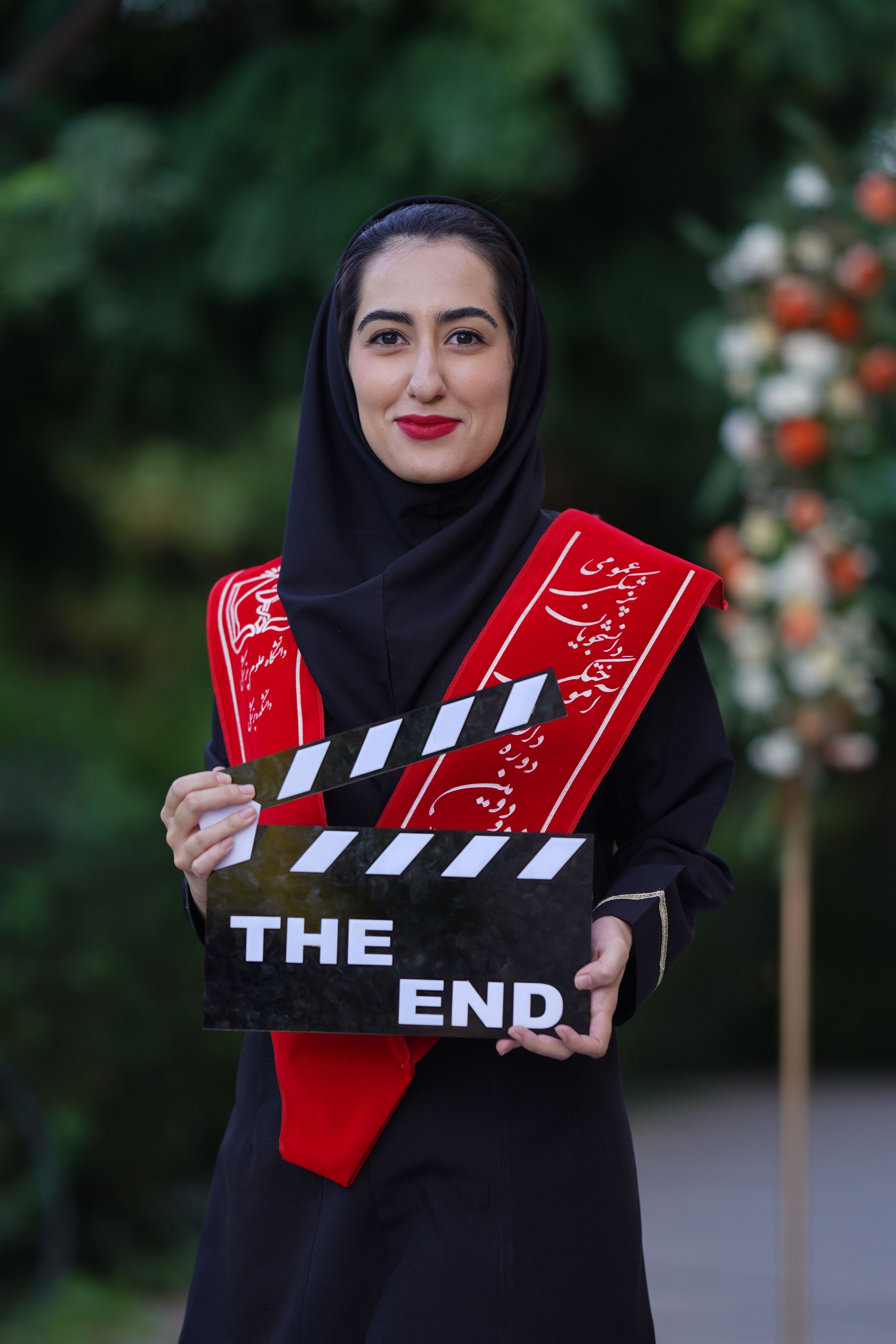 Portrait of Woman Holding Clapperboard Outdoors · Free Stock Photo