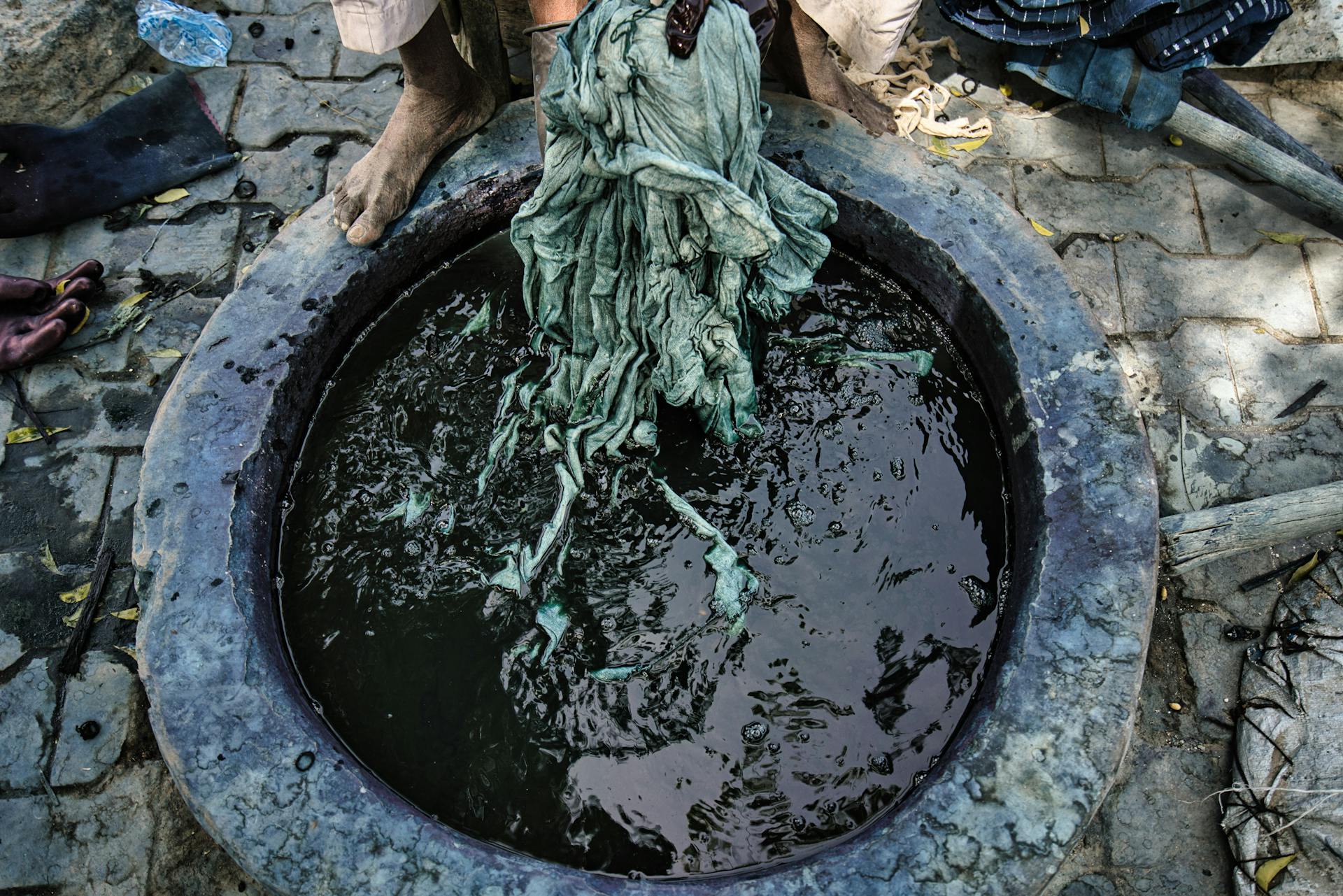 Close-up view of traditional textile dyeing in Kano, Nigeria highlighting African craftsmanship.