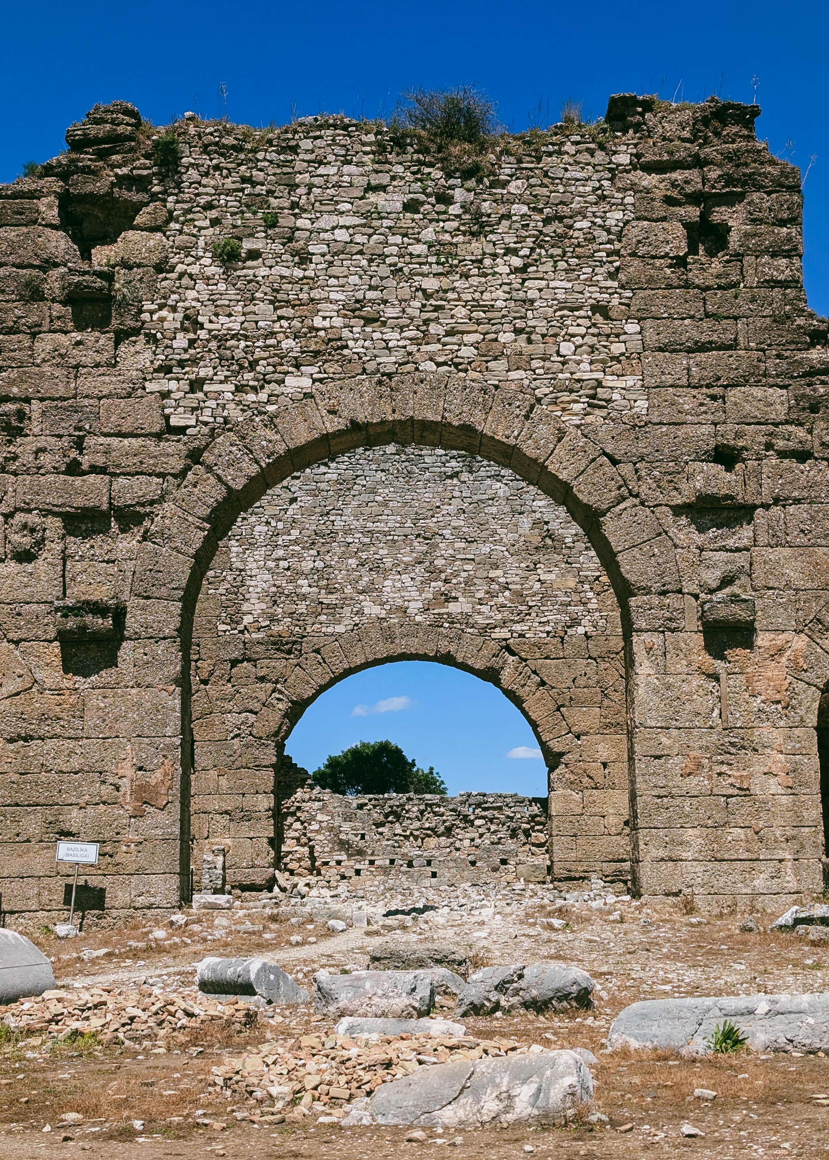 Ancient Stone Archway in Ruins Under Clear Sky · Free Stock Photo