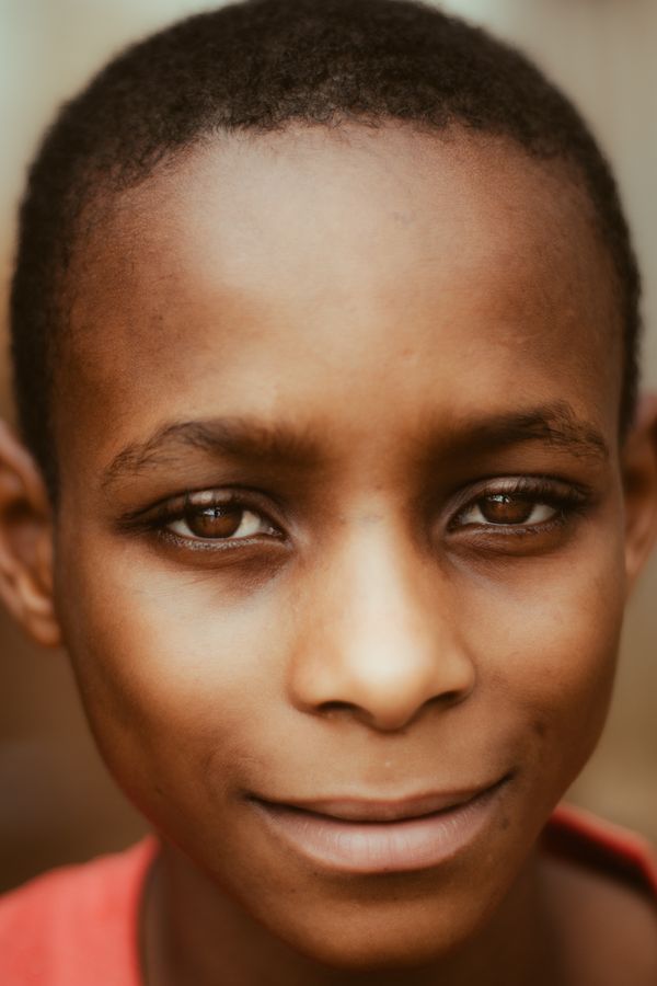 Portrait of a smiling young boy with warm outdoor lighting
