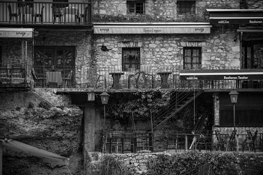 A classic black and white photograph capturing Mostar's historic stone architecture.