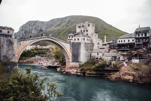 Explore the historic Stari Most bridge in Mostar, Bosnia, overlooking the scenic Neretva River.