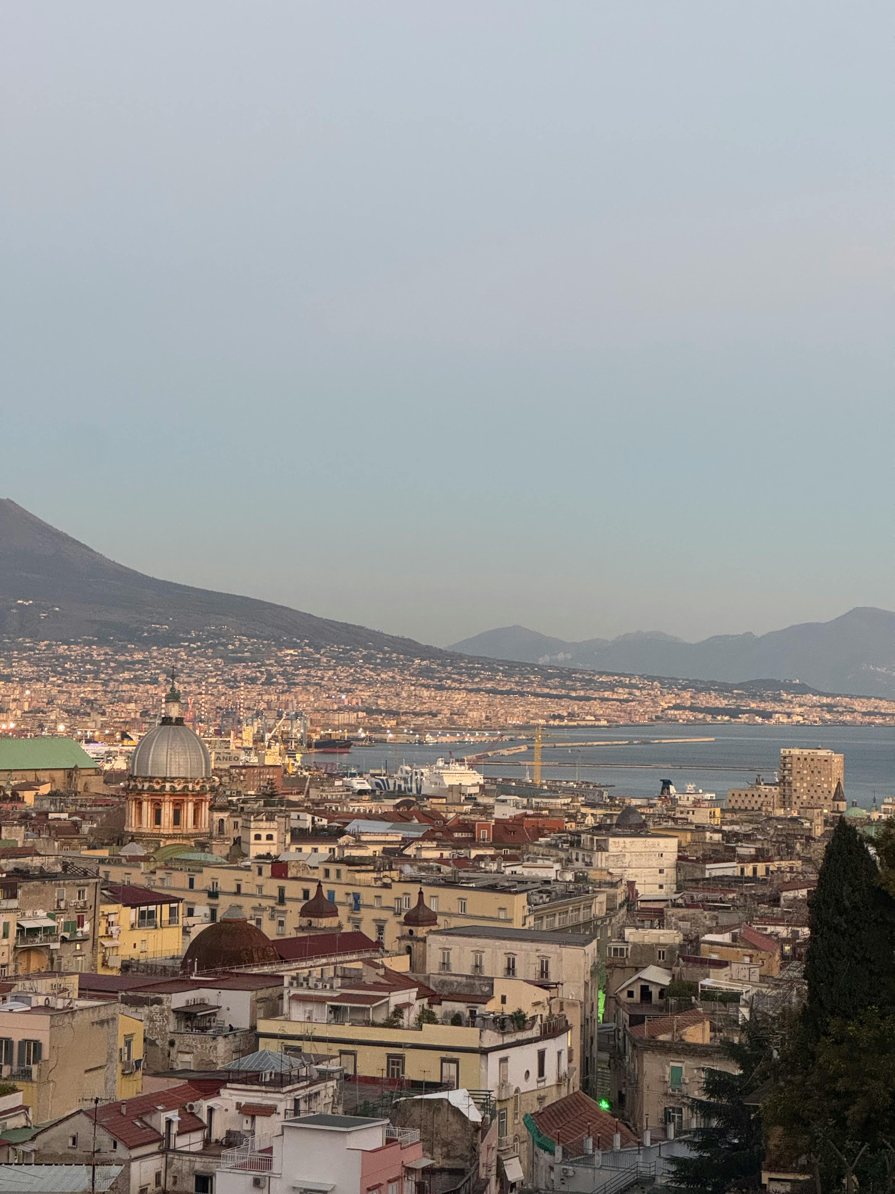 A breathtaking view of Naples with the iconic Mount Vesuvius in the background.