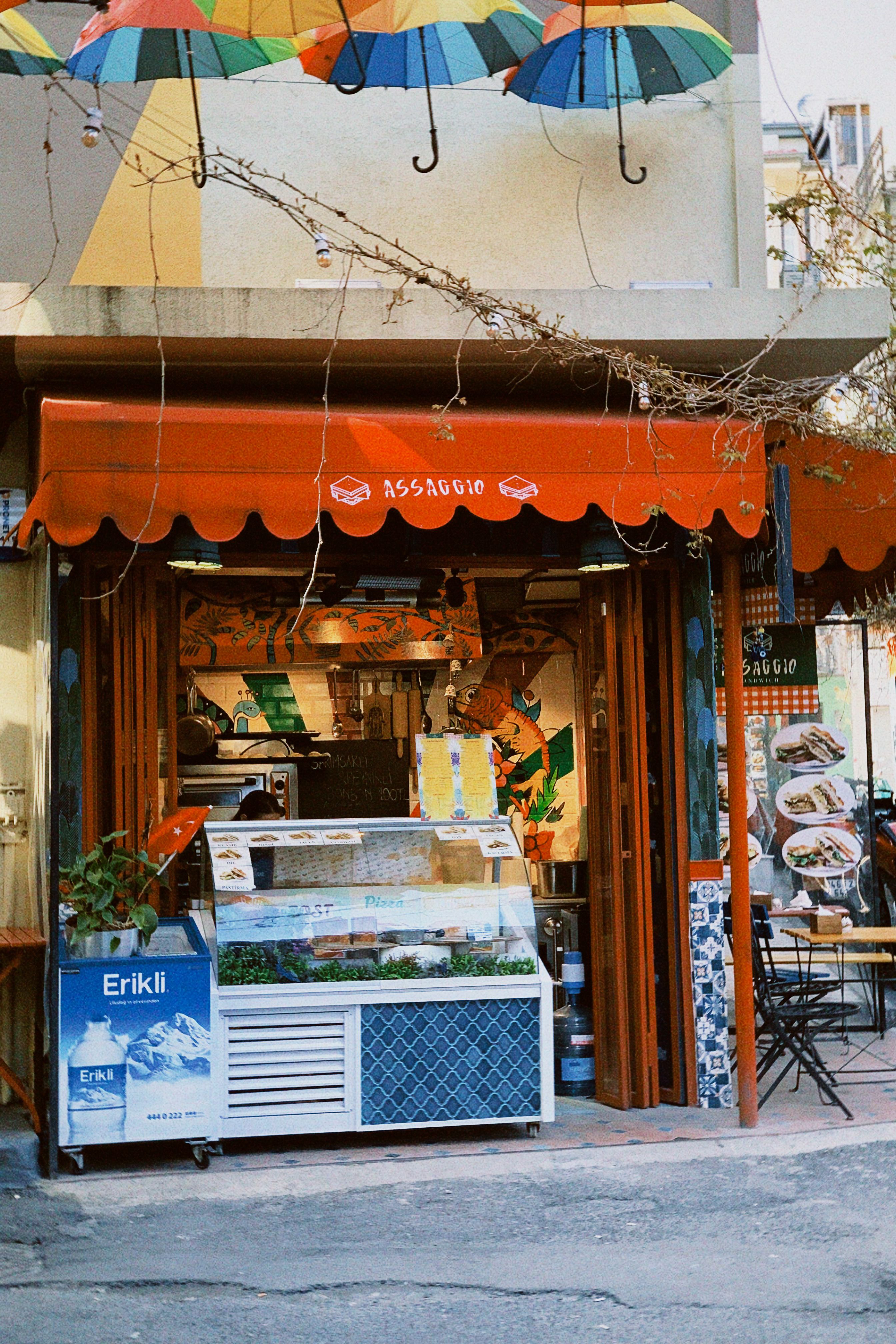 Street view of a cozy café with colorful umbrellas and inviting ambiance.