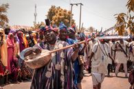Colorful cultural celebration with musicians and dancers in northern Nigeria.