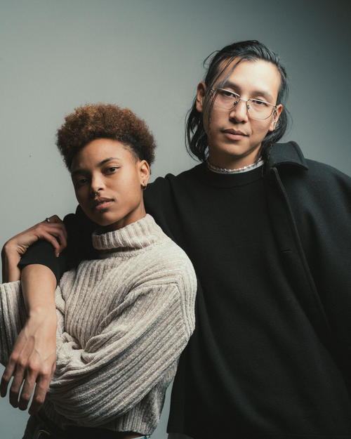 Free Modern studio portrait of two fashionable adults in cozy attire, showcasing diverse style. Stock Photo