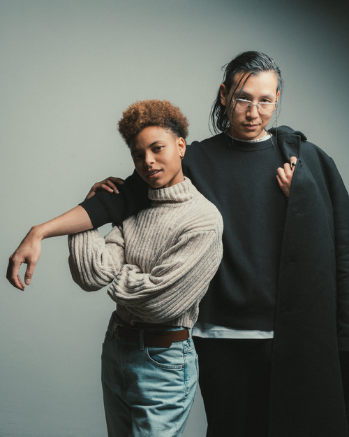 Free Fashionable portrait of two adults in casual, modern outfits, showcasing personal style and friendship. Stock Photo