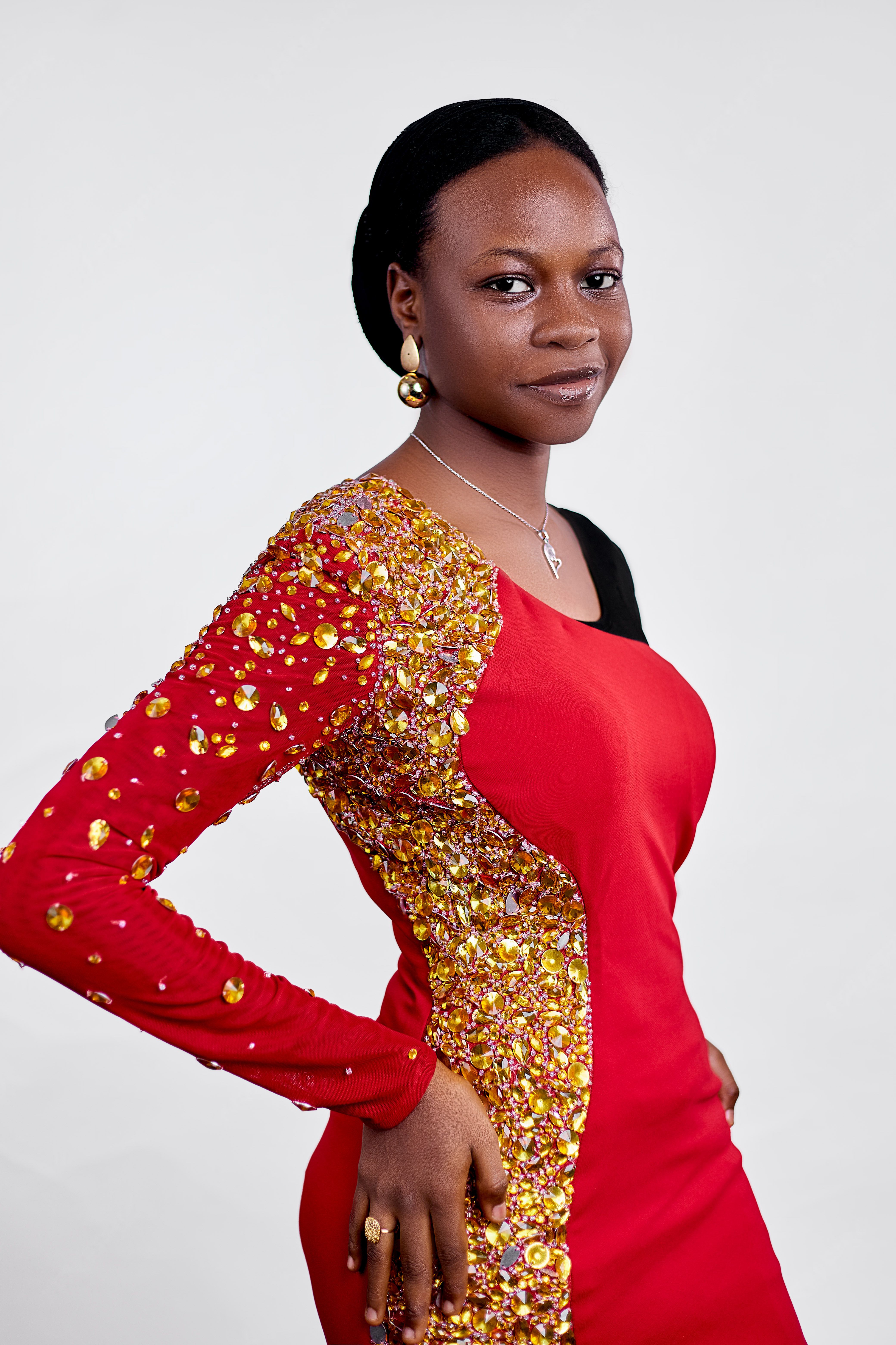 Elegant Woman in Red Sequin Dress Posing · Free Stock Photo