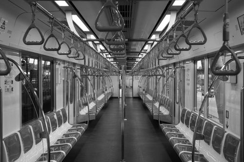 Free A black and white photo of an empty subway train interior, showcasing symmetry and modern design. Stock Photo