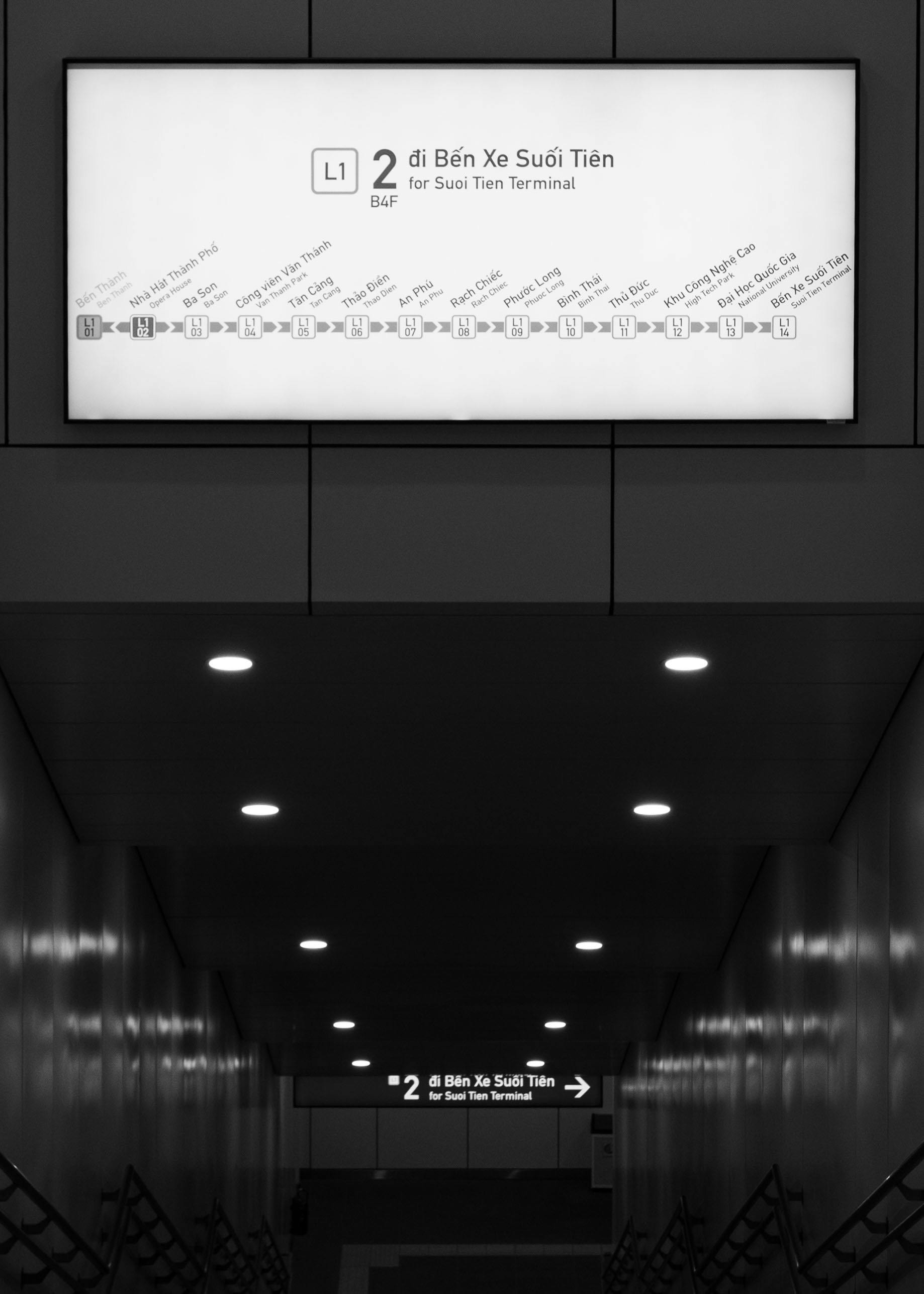 Gratis Fotografía en blanco y negro de la señalización del metro que conduce a la terminal Suoi Tien con luces. Foto de stock