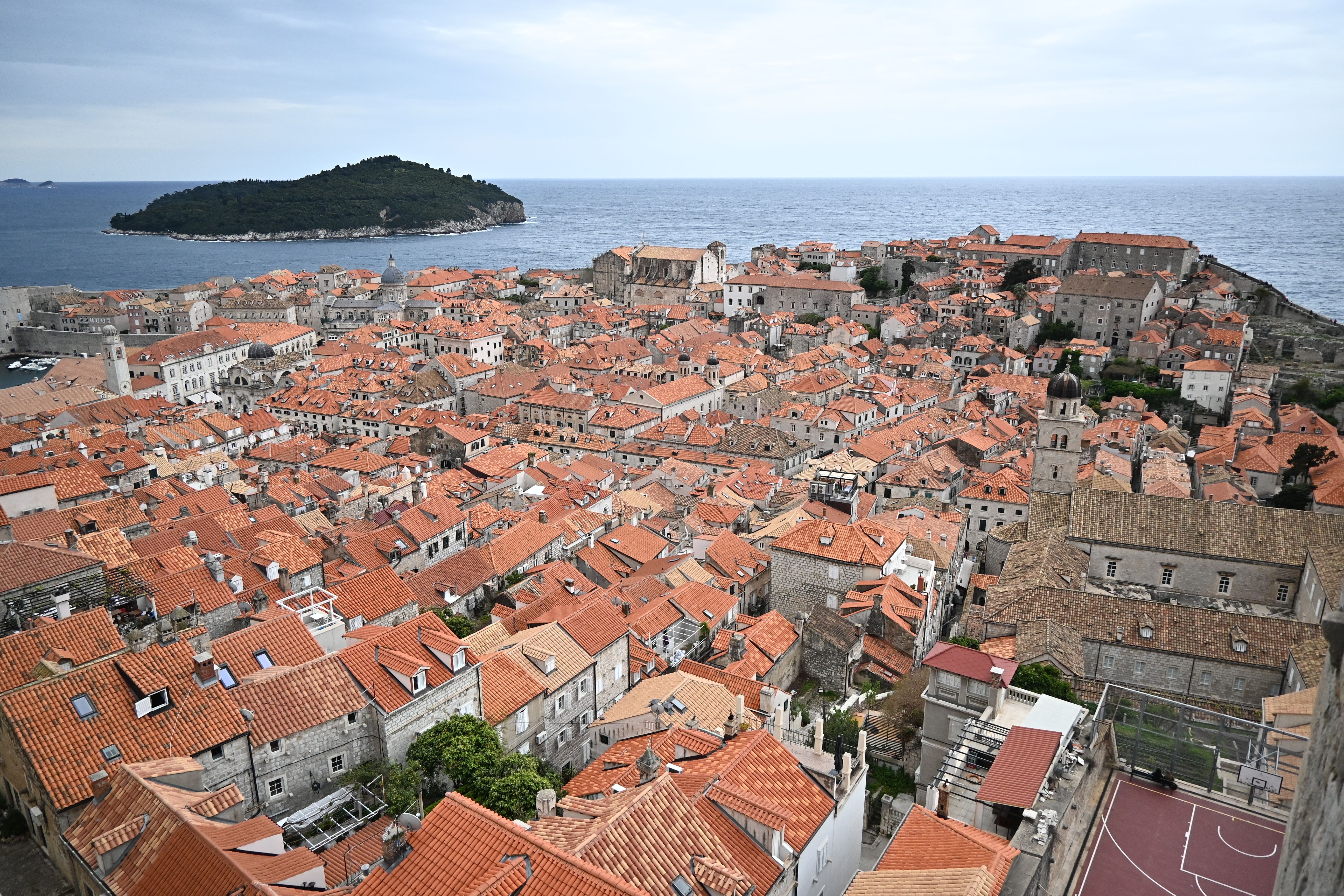 A captivating aerial shot of Dubrovnik's iconic terracotta rooftops overlooking the Adriatic Sea.