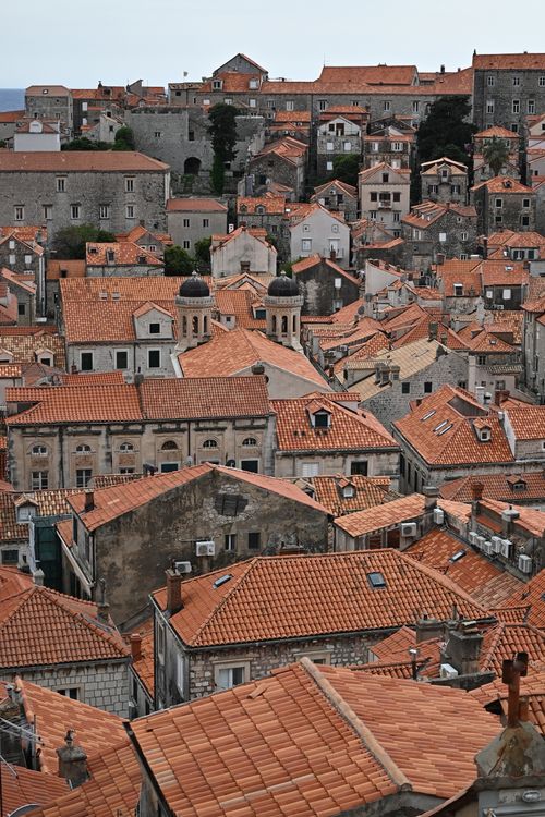 Free Aerial view of Dubrovnik's historic tiled rooftops, capturing the city's unique architecture. Stock Photo