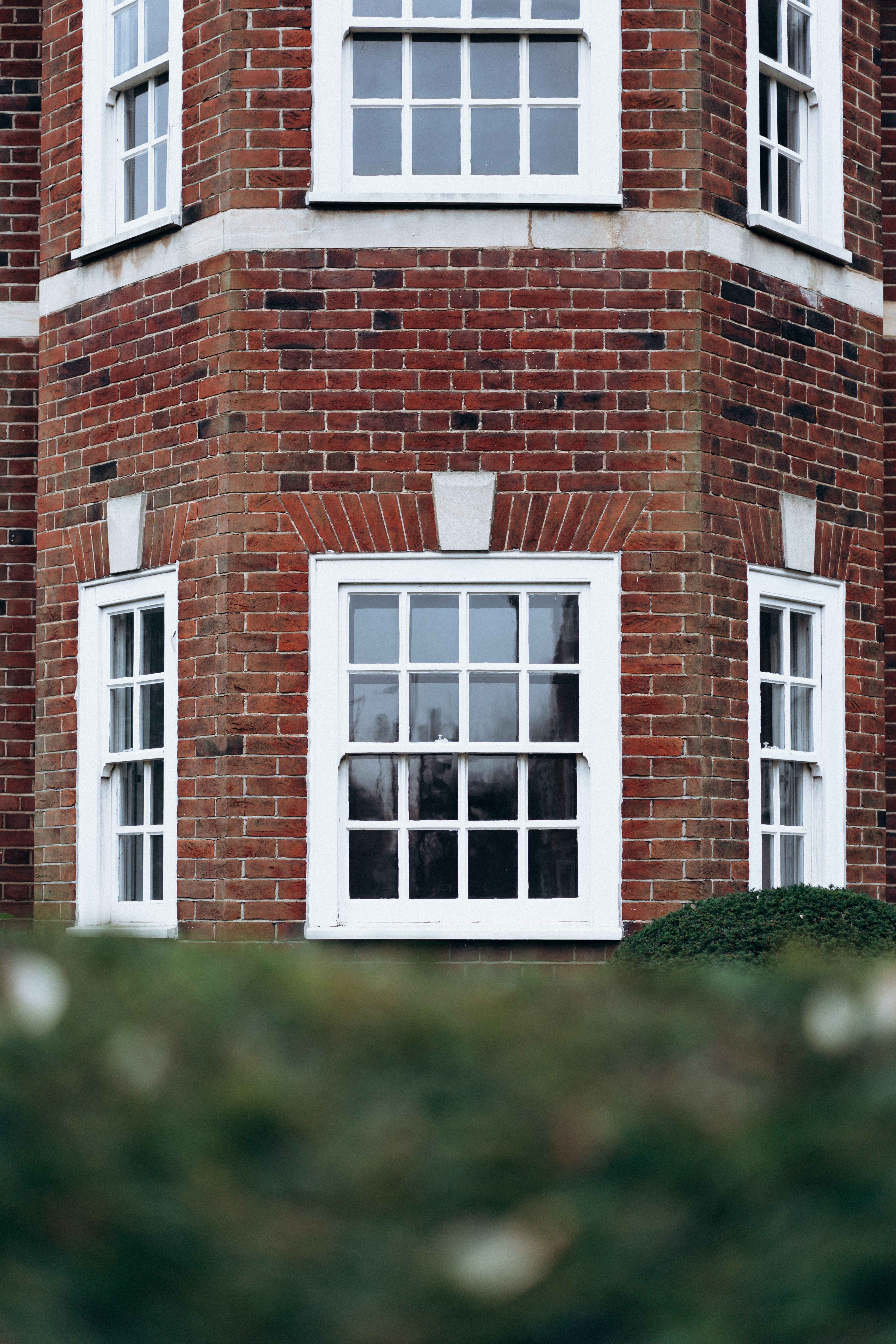 Elegant brickwork facade with white framed windows in London, showcasing classic architectural style.