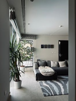 Spacious living room featuring modern design, indoor plants, and comfortable seating.