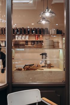 Warm and inviting bakery interior in London showcasing fresh bread and pastries in a display window.