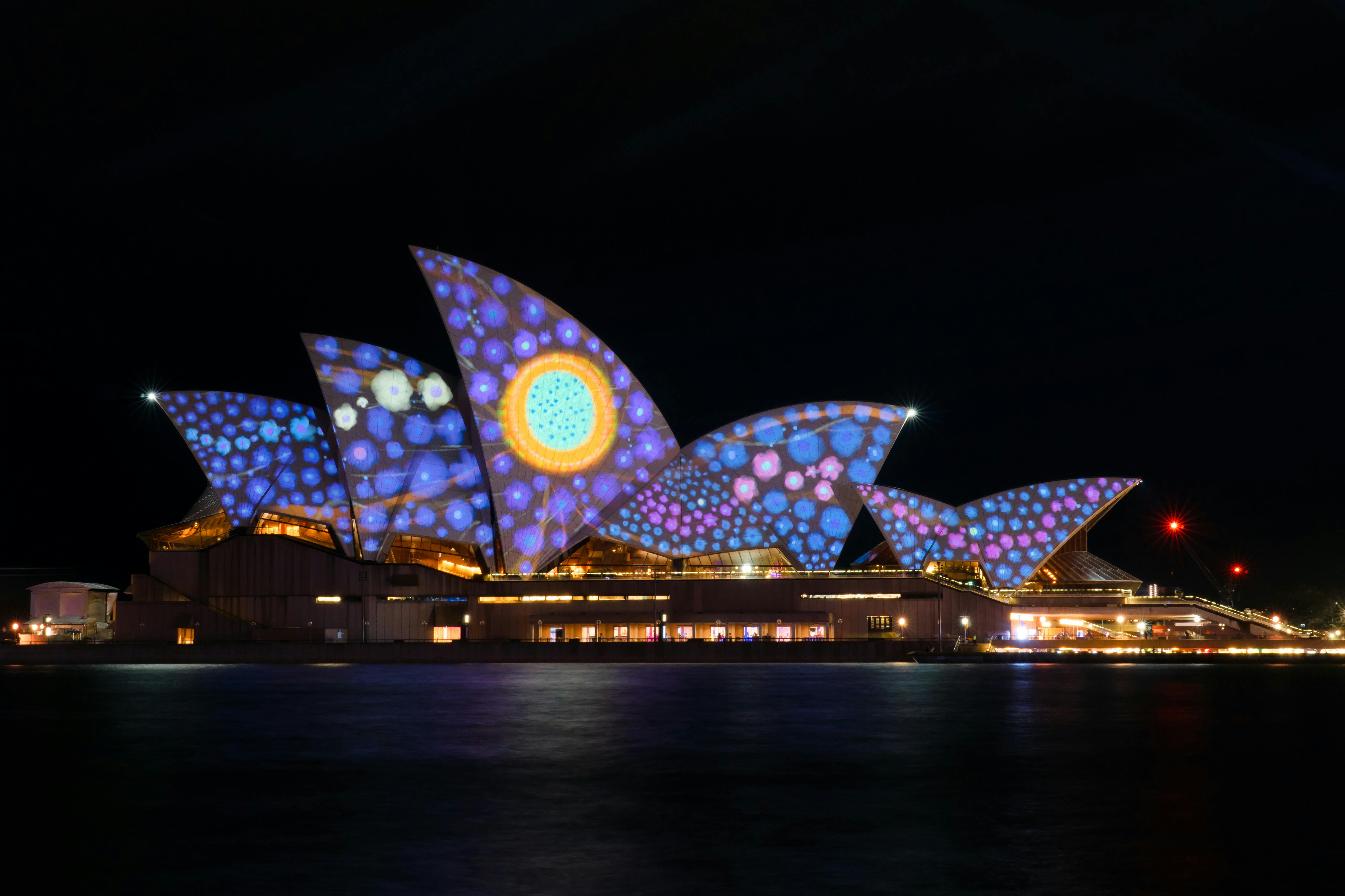 Sydney Opera House lit up with colourful projections during a vibrant night event