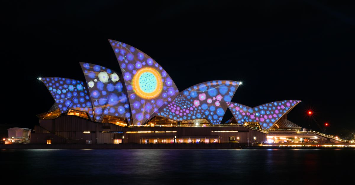 Sydney Opera House lit up with colourful projections during a vibrant night event