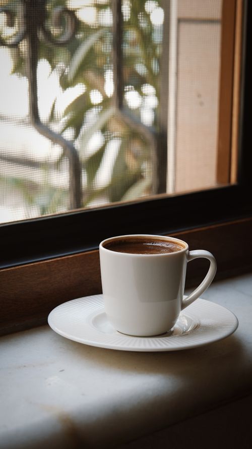 Free A warm cup of Turkish coffee sits by the window, with soft natural light creating a relaxed atmosphere. Stock Photo